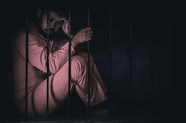 Portrait of man desperate to catch iron prison, prisoner concept - Foto, Bild