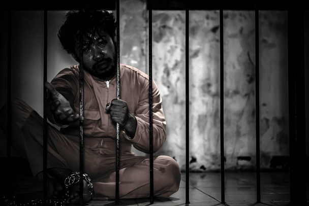 Portrait of man desperate to catch iron prison, prisoner concept - Zdjęcie, obraz