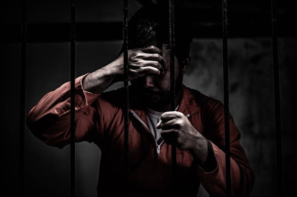 Portrait of man desperate to catch iron prison, prisoner concept - Foto, immagini