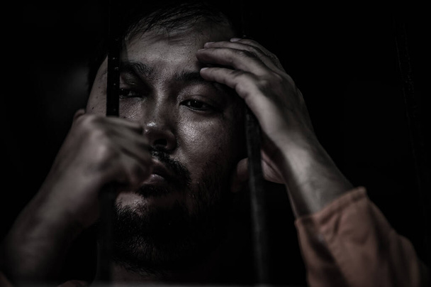 Portrait of man desperate to catch iron prison, prisoner concept - Valokuva, kuva