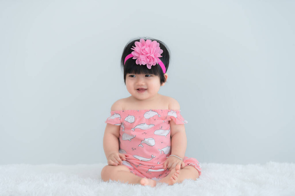 Portrait of cute asian baby on white carpet,Newborn smile for take a photo - 写真・画像