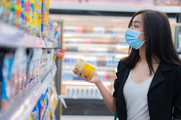 Beautiful asian woman walking shopping in a supermarket,Time for relax,Buy for dinner,Thailand people,Happy time lifestyle concept,Stock up on covid-19 - Photo, Image