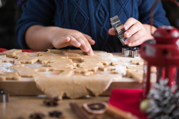 Little cute kid boy  make Christmas gingerbread cookies in the New Year's kitchen. - Photo, image