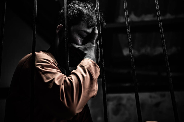 Portrait of man desperate to catch iron prison, prisoner concept - Фото, изображение