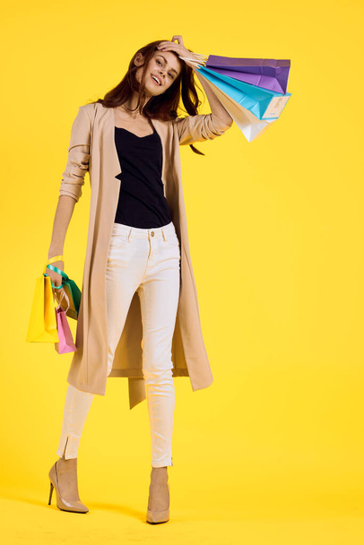 cheerful woman with packages in hands Shopaholic studio model - Фото, изображение