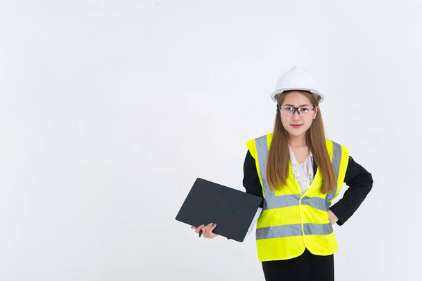 Beautiful asian Engineer woman Wear a suit, glasses and wearing a helmet on white background - Foto, Imagen