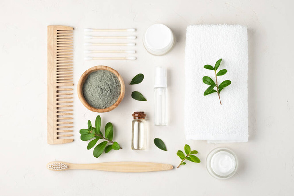 Organic cosmetics for skin care.Cosmetic clay, cotton swabs, face cream, wooden comb, towel, serum for the face. Top view. - Fotoğraf, Görsel