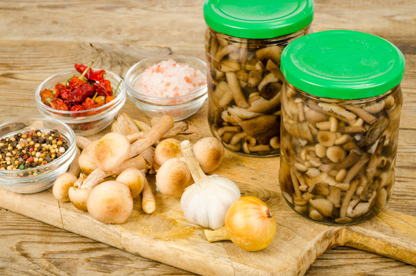 Pickled wild mushrooms in glass jar. Homemade preparations. Studio Photo. - Photo, Image