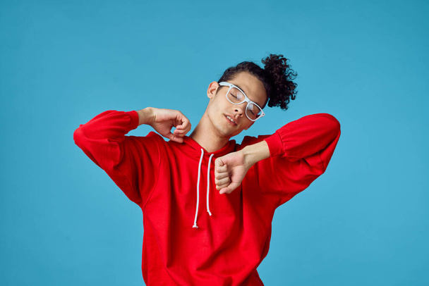 curly guy in a red sweater posing fashion modern hipster style - 写真・画像