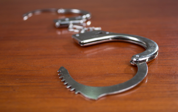 Closeup shot of metallic handcuffs - Fotografie, Obrázek