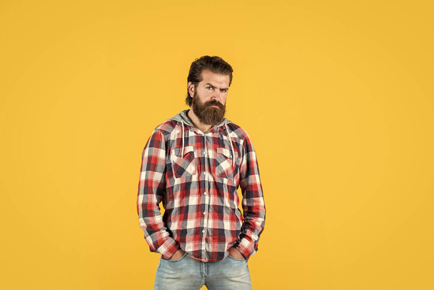 mature handsome man in checkered shirt has beard on face, fashion - Foto, afbeelding