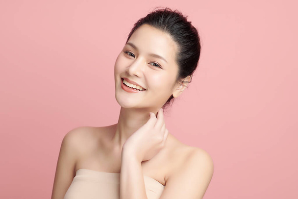Beautiful young asian woman with clean fresh skin on pink background, Face care, Facial treatment, Cosmetology, beauty and spa, Asian women portrait. - 写真・画像