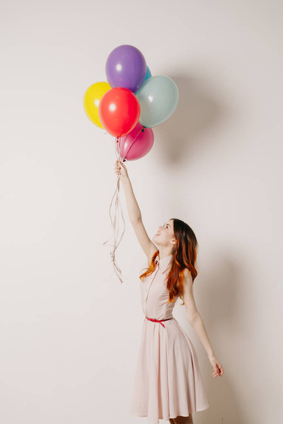 cheerful woman in a dress of colorful balloons - Fotoğraf, Görsel
