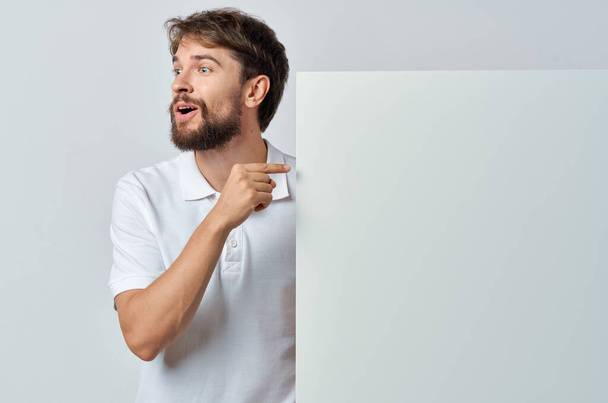 Cheerful man in a white t-shirt mockup poster discount advertising copy-space studio - Photo, Image