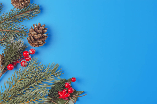 Blue christmas background with fir sprigs and cones with place for text - Φωτογραφία, εικόνα