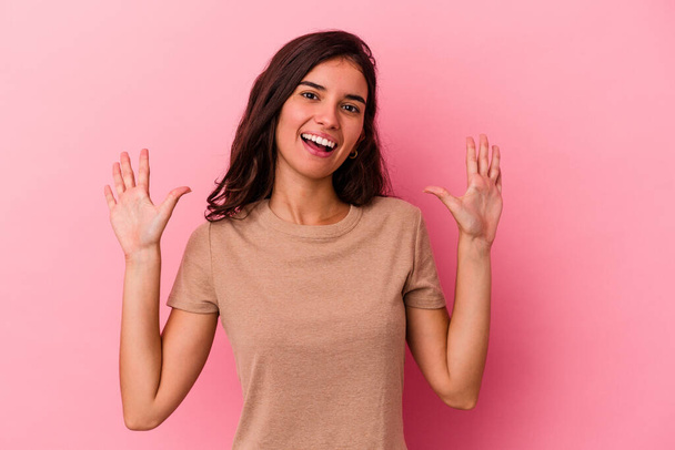 Young caucasian woman isolated on pink background showing number ten with hands. - Photo, Image