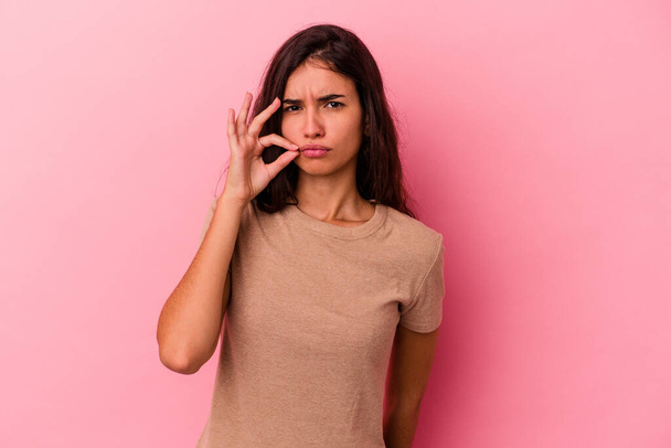 Young caucasian woman isolated on pink background with fingers on lips keeping a secret. - Fotografie, Obrázek