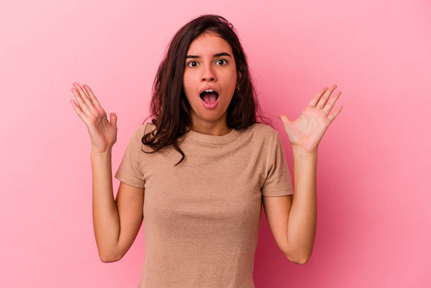 Young caucasian woman isolated on pink background celebrating a victory or success, he is surprised and shocked. - Fotoğraf, Görsel