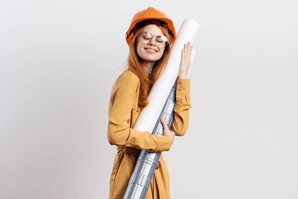 female engineer in orange hard hat blueprints architect - Φωτογραφία, εικόνα