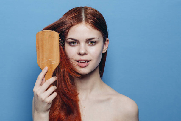 pretty woman combing hair bare shoulders hair care - Valokuva, kuva