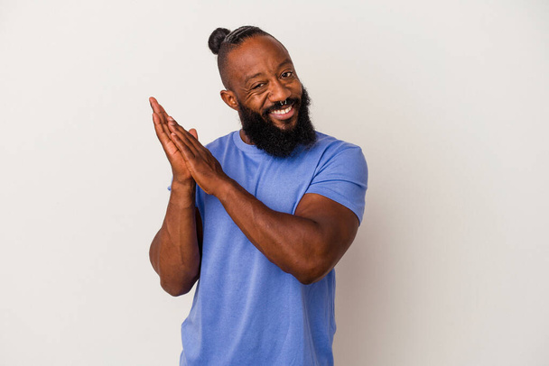 African american man with beard isolated on pink background feeling energetic and comfortable, rubbing hands confident. - Photo, image