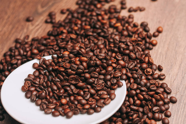 coffee beans Hot drink spilled grains wooden table - Valokuva, kuva