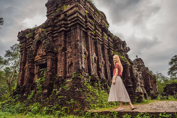 Woman tourist in Temple ruin of the My Son complex, Vietnam. Vietnam opens to tourists again after quarantine Coronovirus COVID 19 - 写真・画像