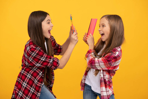 crianças felizes em camisa xadrez casual se divertindo com cadernos, escola - Foto, Imagem