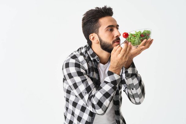 emotional bearded man in plaid shirt plate with salad - Foto, immagini