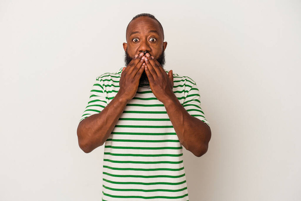 African american man with beard isolated on pink background shocked, covering mouth with hands, anxious to discover something new. - Foto, Bild