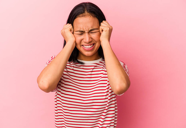 Young Venezuelan woman isolated on pink background crying, unhappy with something, agony and confusion concept. - Photo, Image
