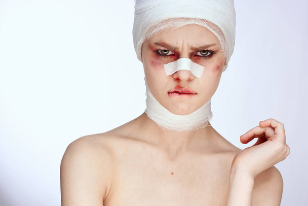woman tampon in the nose with blood injured face isolated background - Foto, Bild