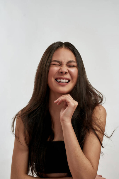Vertical shot of smiling Asian woman laugh - 写真・画像