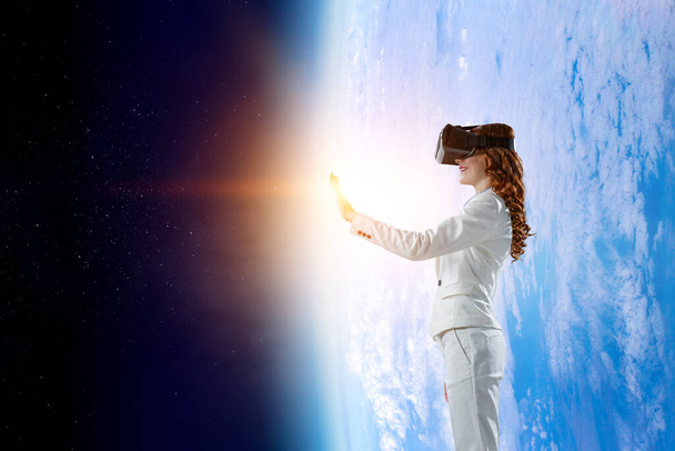 Woman wearing virtual reality goggles - Фото, изображение