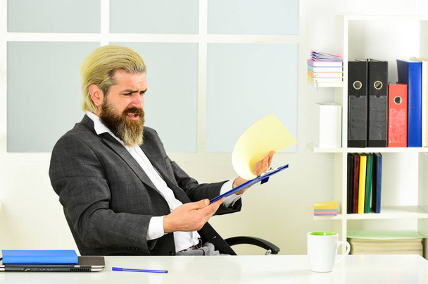 angry bearded man in formal jacket sit at table. boss in workplace. modern office life. distant work while coronavirus quarantine. mature school teacher. Business-minded businessman - Photo, Image