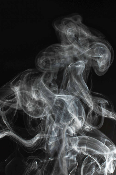 A vertical shot of smoke on a dark background - Photo, image