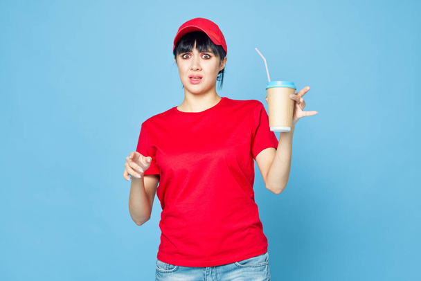 woman in red uniform cup of coffee blue background fun - Фото, зображення