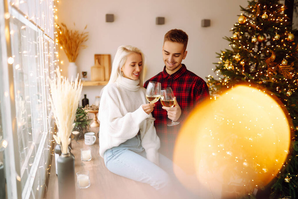 Young couple together celebrating christmas at decorated home.  Romantic day. Winter holidays. - Fotoğraf, Görsel