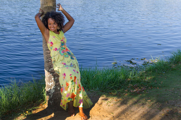 Beautiful model wearing yellow dress. In the background, nature. Salvador, Bahia, Brazil. - Photo, Image
