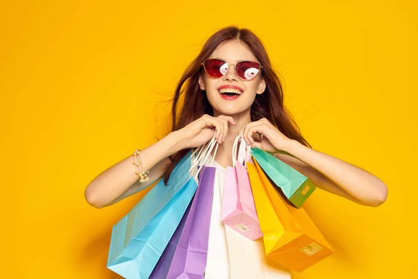 glamorous woman with packages in hands Shopaholic isolated background - Фото, зображення
