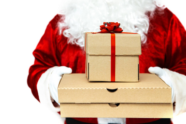 Pizza boxes and a gift in the hands of Santa Claus.  Christmas fast food delivery.  New year's eve promotion. Isolated on white.  - 写真・画像