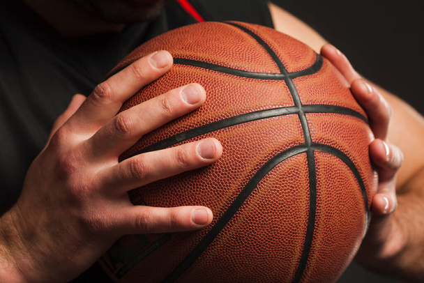 close up hand held basketball. High quality photo - Foto, Bild