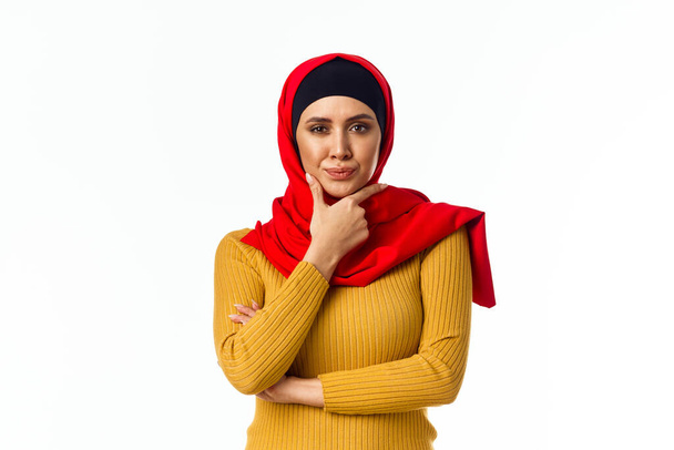 cheerful muslim woman shopping holiday gifts light background - Foto, imagen
