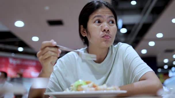 Asian woman eating at the food court - Footage, Video