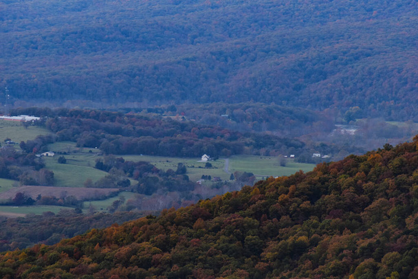 Looking Down at a Farm from a Mountainside on a Sunny Fall Afternoon - Photo, Image