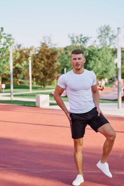 athletic men doing exercises on the sports ground in summer - Foto, immagini