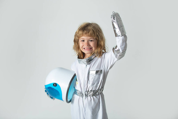 Amazed boy playing to be an astronaut with space helmet and metal suit. - Foto, Imagem