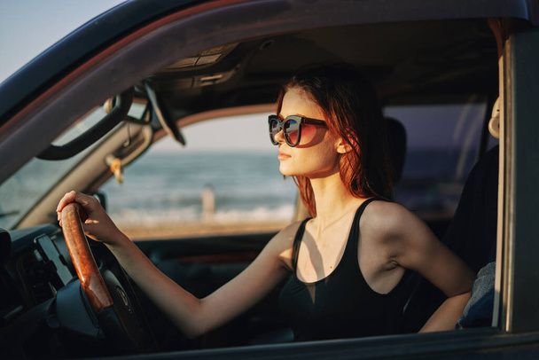 cheerful woman in sunglasses driving a car trip travel - Fotografie, Obrázek