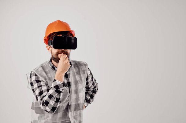 trabalhador masculino em uma tecnologia de capacete laranja Fundo de luz profissional - Foto, Imagem