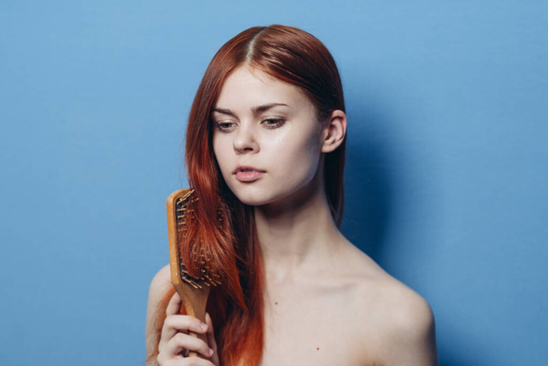 pretty woman combing hair bare shoulders hair care - Foto, Imagen
